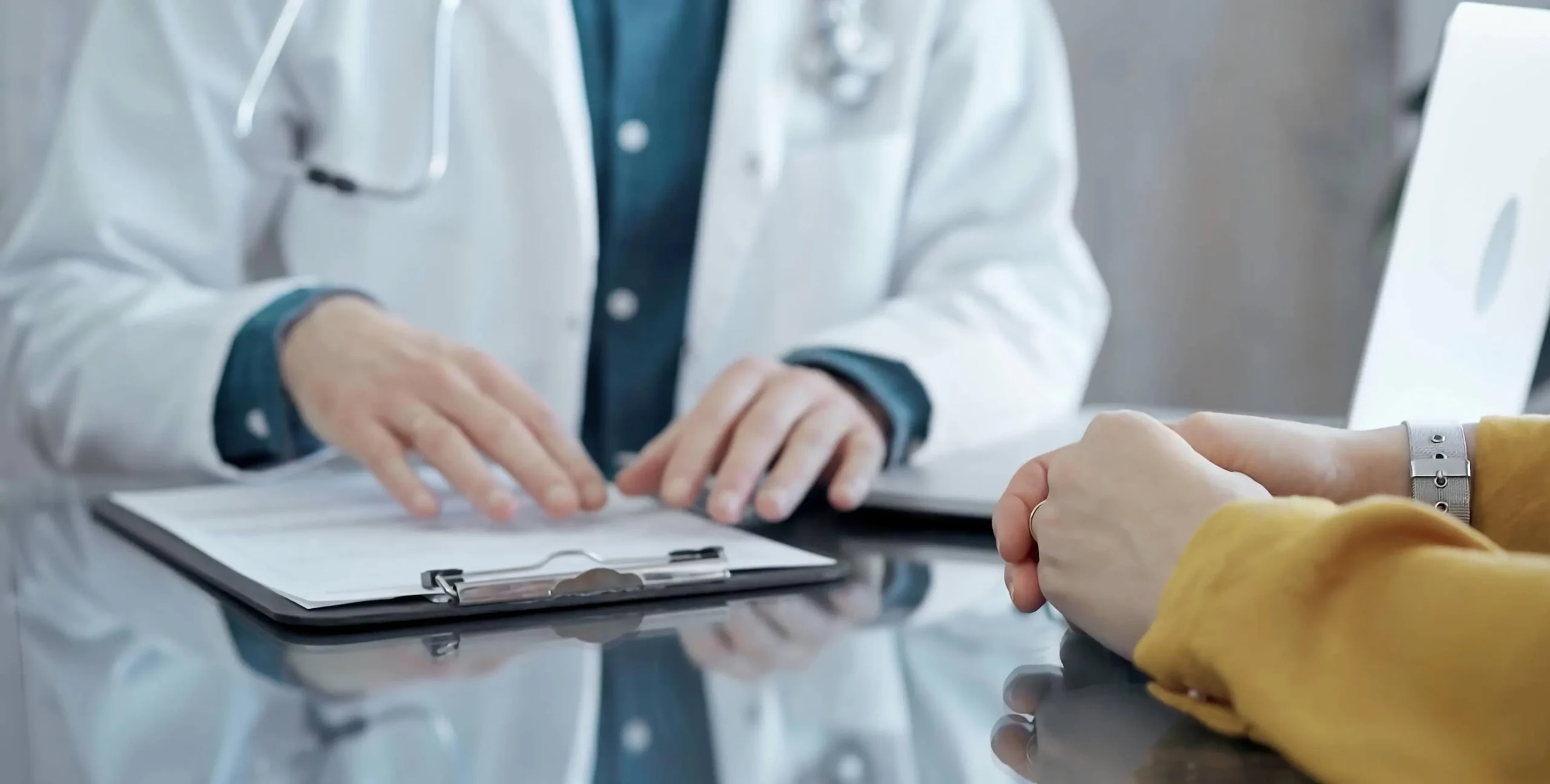 close up of doctors hands during discussion with patient